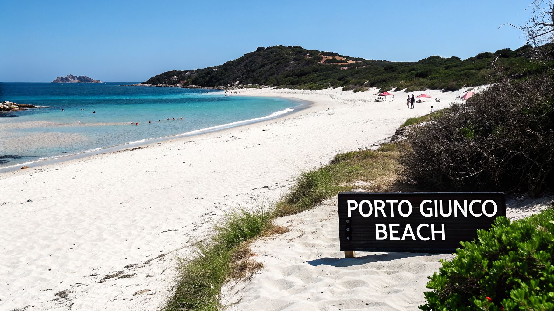 Porto Giunco Beach with white sand, turquoise water, swimmers, and distant hills under a clear blue sky.