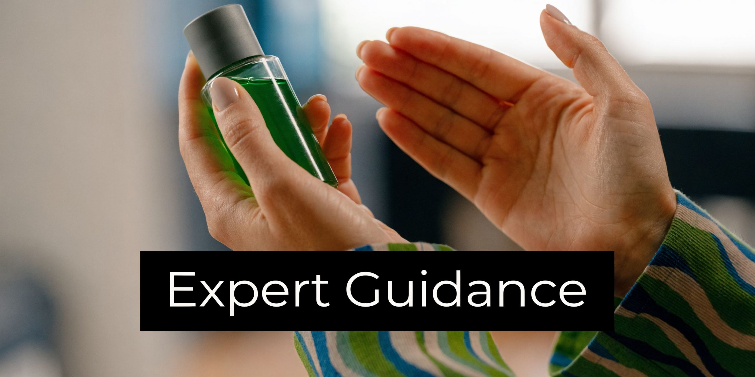 A close-up of a person holding a small green skincare bottle, demonstrating a beauty product application routine.