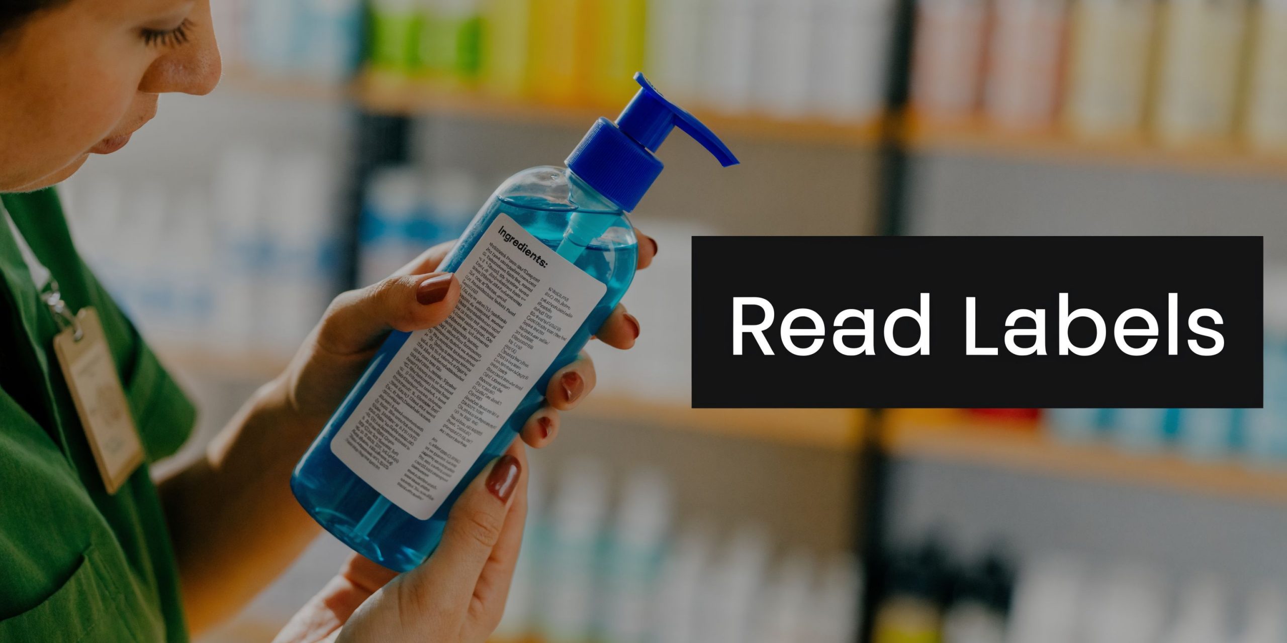 A pharmacist carefully examines the ingredient label on a bottle of blue liquid in a pharmacy.