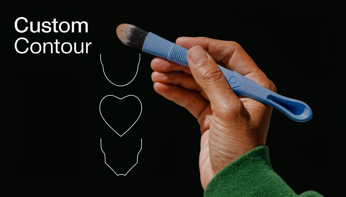 A hand holds a blue makeup brush next to drawn white outlines of different face shapes.