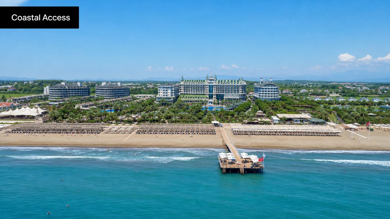 An aerial view of the Crystal Waterworld Resort and Spa hotel with a private beach and pier.