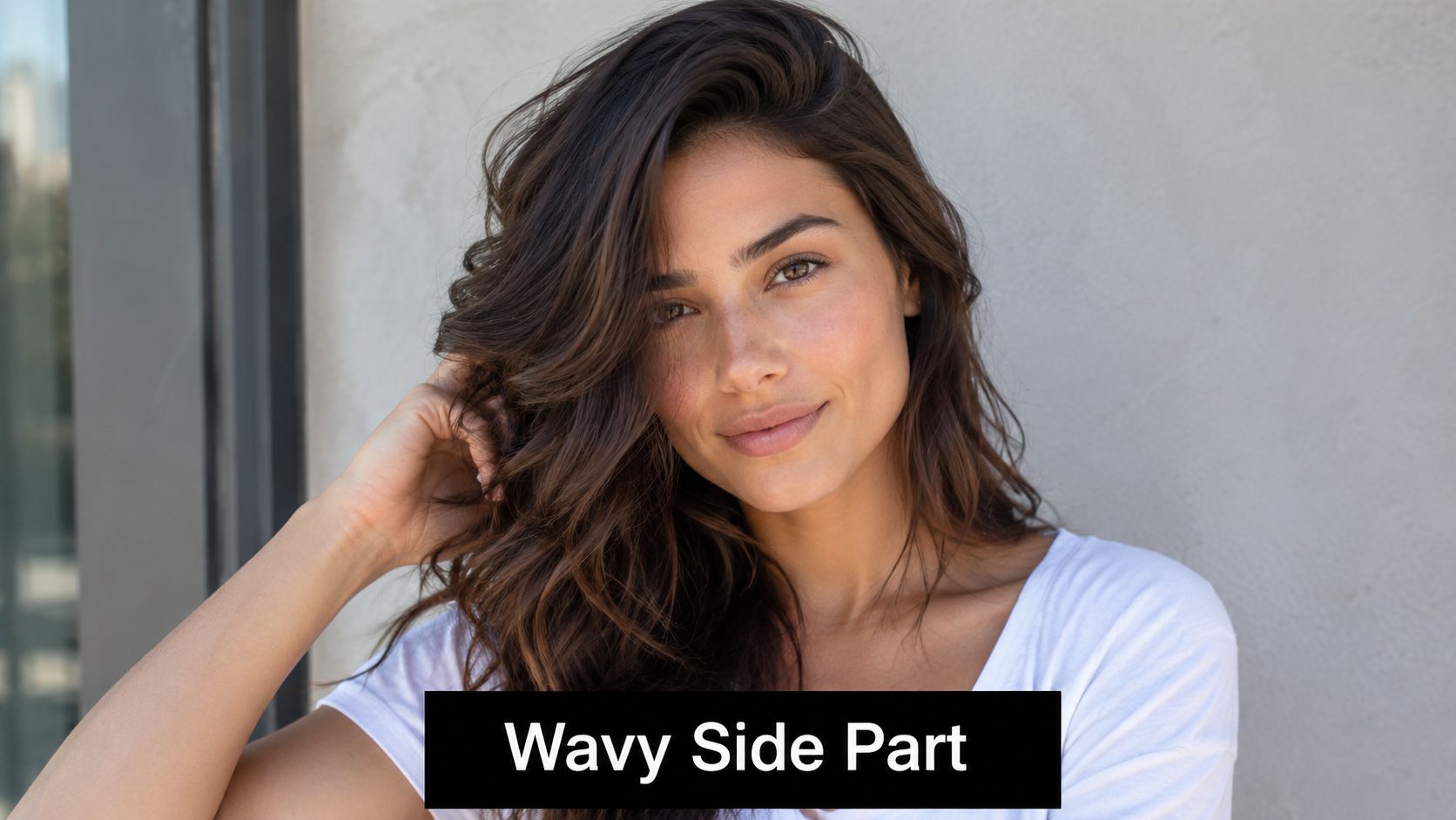 A beautiful woman with long, voluminous, dark brown hair styled in a deep wavy side part.
